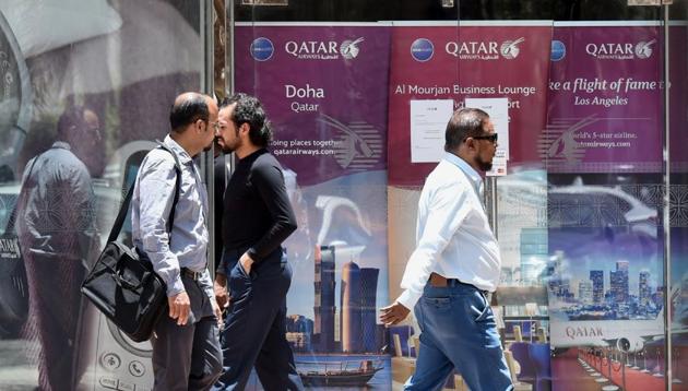 People walk past the Qatar Airways branch in the Saudi capital Riyadh, after it had suspended all flights to Saudi Arabia following a severing of relations between major Gulf states and gas-rich Qatar. Saudi Arabia was among the nations that closed its borders with Qatar, effectively blocking food and other supplies exported by land to Qatar.(AFP)