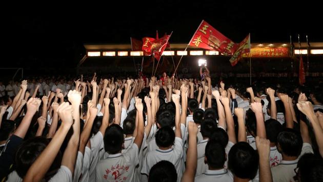 Teachers wave flags as they cheer for students ahead of China's annual National College Entrance Exam. (Jason Lee/REUTERS) Teachers wave flags as they cheer for students ahead of China's annual National College Entrance Exam. (Jason Lee/REUTERS)