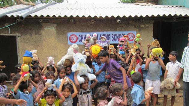 Underprivileged children pose with their new toys.