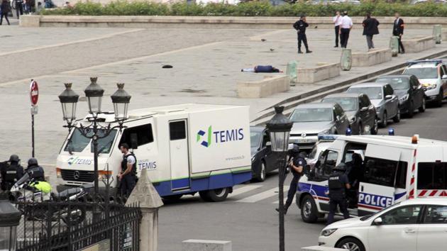 Paris : This photo provided by David Metreau and dated Tuesday, June 6, 2017, shows a man, upper center right, who attacked a police officer laying wounded on the esplanade of Notre Dame cathedral in Paris, France, Tuesday, June 6, 2017. Paris police say an unidentified assailant has attacked a police officer near the Notre Dame Cathedral, and the officer then shot and wounded the attacker. AP/PTI Photo(AP6_6_2017_000223B) (AP) Paris : This photo provided by David Metreau and dated Tuesday, June 6, 2017, shows a man, upper center right, who attacked a police officer laying wounded on the esplanade of Notre Dame cathedral in Paris, France, Tuesday, June 6, 2017. Paris police say an unidentified assailant has attacked a police officer near the Notre Dame Cathedral, and the officer then shot and wounded the attacker. AP/PTI Photo(AP6_6_2017_000223B) (AP)