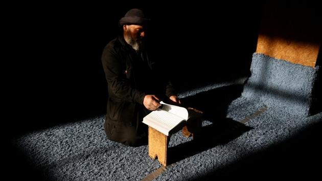 A man reads the Quran during Ramadan in the rebel held Damascus suburb of Ghouta. (REUTERS) A man reads the Quran during Ramadan in the rebel held Damascus suburb of Ghouta. (REUTERS)