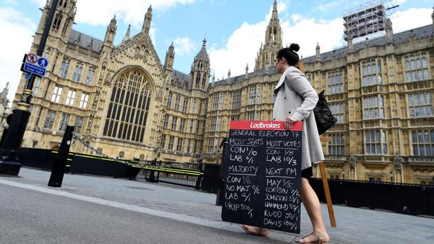 A betting shop worker carries a board displaying odds for scenarios in the general election outside the Houses of Parliament in Westminster, London. Britain on Wednesday headed into the final day of campaigning for a general election darkened and dominated by jihadist attacks in two cities, leaving forecasters struggling to predict an outcome on polling day. (Clodagh Kilcoyne/REUTERS) A betting shop worker carries a board displaying odds for scenarios in the general election outside the Houses of Parliament in Westminster, London. Britain on Wednesday headed into the final day of campaigning for a general election darkened and dominated by jihadist attacks in two cities, leaving forecasters struggling to predict an outcome on polling day. (Clodagh Kilcoyne/REUTERS)