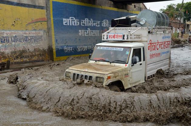 A jeep moves through a waterlogged road after heavy rains in Mirzapur. (PTI)