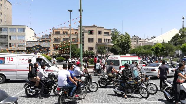 A scene outside the Iranian parliament following an attack on the complex with police and ambulances arriving in response. (Atta Kenare/AFP)