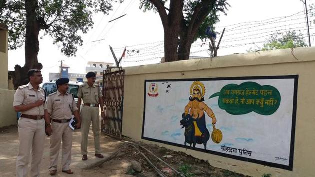 Superintendent of Police -Kathik S (extreme right) before a wall painting displaying safety message in Lohardaga (HT Photo) Superintendent of Police -Kathik S (extreme right) before a wall painting displaying safety message in Lohardaga (HT Photo)