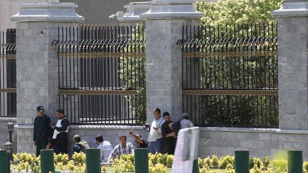 Iranian forces and civilians take cover during as gunmen attack the parliament building in central Tehran. (REUTERS)