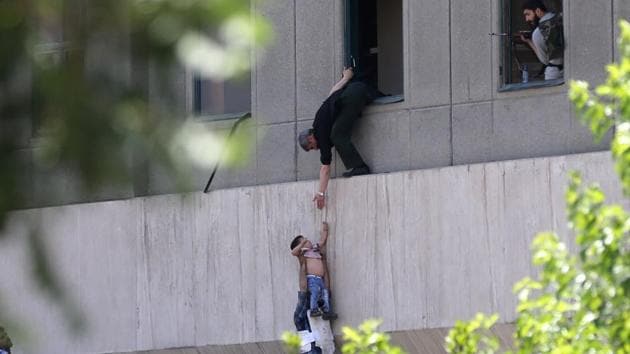 Iranian policemen evacuate a child from the parliament building in Tehran on June 7, 2017 during an attack on the complex. (AFP Photo) Iranian policemen evacuate a child from the parliament building in Tehran on June 7, 2017 during an attack on the complex. (AFP Photo)