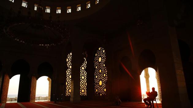 A Palestinian man reads from the Quran, during the holy Muslim fasting month of Ramadan at a mosque in Gaza City. Ramadan is underway with Muslims across the world engaged in fasting, prayer and efforts towards spiritual cleansing.The fast is one of the five main obligations under the religion. While the core tenets of abstinence and restraint from vices are common throughout, local customs and factors also play a part in shaping the Ramadan experience across regions. (AFP) A Palestinian man reads from the Quran, during the holy Muslim fasting month of Ramadan at a mosque in Gaza City. Ramadan is underway with Muslims across the world engaged in fasting, prayer and efforts towards spiritual cleansing.The fast is one of the five main obligations under the religion. While the core tenets of abstinence and restraint from vices are common throughout, local customs and factors also play a part in shaping the Ramadan experience across regions. (AFP)