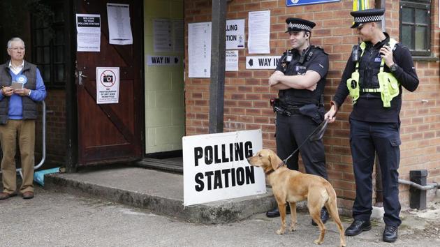 Police officers stand outside a polling station in Maidenhead, England before Britain's Prime Minister Theresa May arrived to vote in the general election. (Alastair Grant / AP) Police officers stand outside a polling station in Maidenhead, England before Britain's Prime Minister Theresa May arrived to vote in the general election. (Alastair Grant / AP)