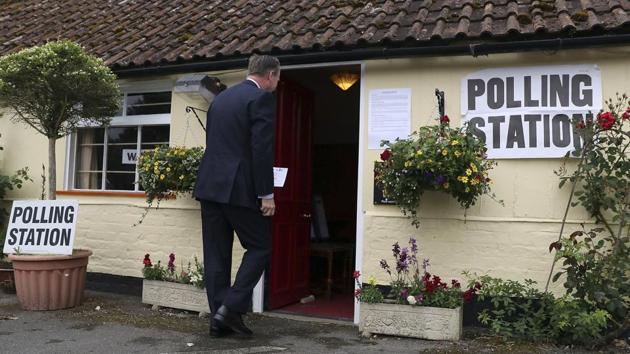 A man enters the polling station at the Golden Pheasant Public House in Lower Farringdon, Hampshire, England. (Andrew Matthews / AP) A man enters the polling station at the Golden Pheasant Public House in Lower Farringdon, Hampshire, England. (Andrew Matthews / AP)