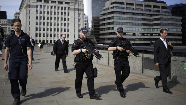 Armed police officers patrol on London Bridge. Officials said a large part of the crime scene has reopened. (AP) Armed police officers patrol on London Bridge. Officials said a large part of the crime scene has reopened. (AP)