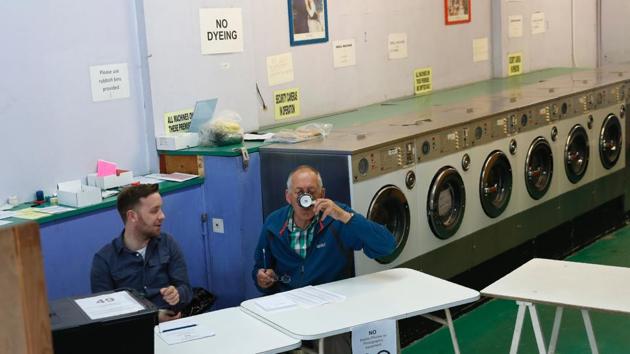 A presiding officer (R) and poll clerk wait for early morning voters at a Polling Station set up in a launderette and nail bar in Headington outside Oxford, west of London. (Adrian Dennis / AFP) A presiding officer (R) and poll clerk wait for early morning voters at a Polling Station set up in a launderette and nail bar in Headington outside Oxford, west of London. (Adrian Dennis / AFP)