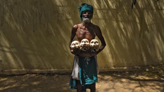 Palanichamy, a farmer from Tamil Nadu holds the skulls of those who allegedly committed suicide back home during the protest demanding aid from government in New Delhi, in May. The farmers’ novel means of protest garnered widespread attention in the media. (Ravi Choudhary/HT PHOTO)