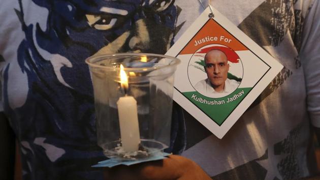 A man holds a candle as he participates in a demonstration in support of naval officer Kulbhushan Jadhav in Mumbai. (AP File Photo) A man holds a candle as he participates in a demonstration in support of naval officer Kulbhushan Jadhav in Mumbai. (AP File Photo)