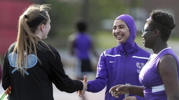 In this May 24, 2017 photo, Tabarek Kadhim (centre) congratulates an opponent after a tennis match in Windham, Maine. Deering High School is providing sport hijabs to make Muslim girls comfortable and boost their participation in sports. Tennis co-captains Liva Pierce and Anaise Manikunda solicited private donations to avoid criticism for using taxpayer funds on religious apparel, and ended up with enough to outfit all teams, including lacrosse, soccer, volleyball, softball, field hockey and track. (AP) In this May 24, 2017 photo, Tabarek Kadhim (centre) congratulates an opponent after a tennis match in Windham, Maine. Deering High School is providing sport hijabs to make Muslim girls comfortable and boost their participation in sports. Tennis co-captains Liva Pierce and Anaise Manikunda solicited private donations to avoid criticism for using taxpayer funds on religious apparel, and ended up with enough to outfit all teams, including lacrosse, soccer, volleyball, softball, field hockey and track. (AP)