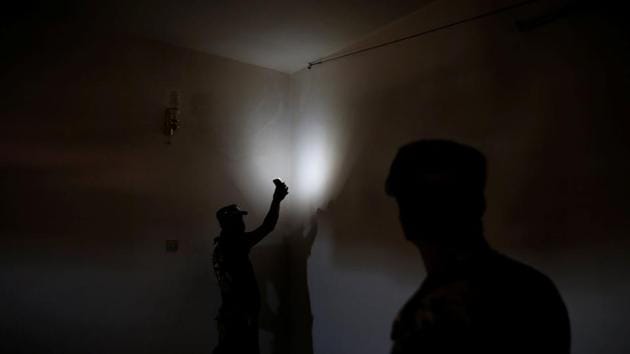 Members of the Iraqi Army inspect the cables of the surveillance system inside a compound previously used as prison by the Islamic State. These cameras were linked to the guards office who kept a tight vigil on the prisoners and their activity. (Alkis Konstantinidis /REUTERS) Members of the Iraqi Army inspect the cables of the surveillance system inside a compound previously used as prison by the Islamic State. These cameras were linked to the guards office who kept a tight vigil on the prisoners and their activity. (Alkis Konstantinidis /REUTERS)