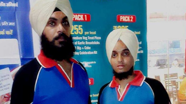Pizza delivery boys Surender Singh (L) and Harpeet Singh at their outlet on VIP Road in Zirakpur.