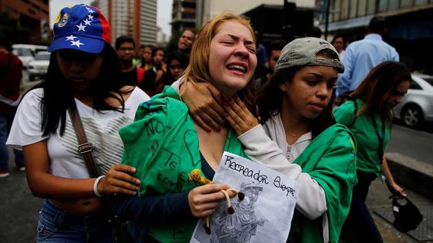 A woman reacts at the place where 17-year-old demonstrator died during riots at a rally against Venezuelan government.  (REUTERS) 