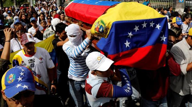 Mourners carry the coffin of Neomar Lander during his funeral in Guarenas, Venezuela.  (Carlos Garcia Rawlins/REUTERS) 