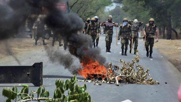 Police personnel patrol a stretch of the Indore-Bhopal highway frequented by protesters on Friday. (PTI photo) Police personnel patrol a stretch of the Indore-Bhopal highway frequented by protesters on Friday. (PTI photo)