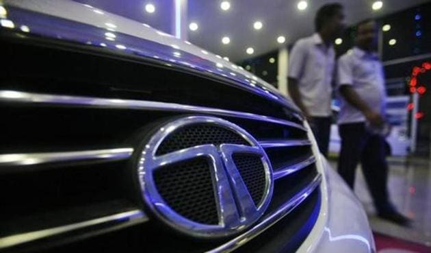 Men walk inside a Tata Motors showroom.(Reuters) Men walk inside a Tata Motors showroom.(Reuters)