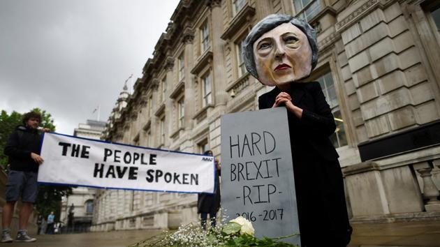 A protestor wearing a Theresa May mask is seen the day after Britain's election in London on June 9, 2017. (Reuters)