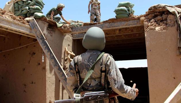 Afghan Border Police personnel walk through an outpost damaged in an airstrike in the Nad Ali district of Helmand province on June 10, 2017. (AFP) Afghan Border Police personnel walk through an outpost damaged in an airstrike in the Nad Ali district of Helmand province on June 10, 2017. (AFP)