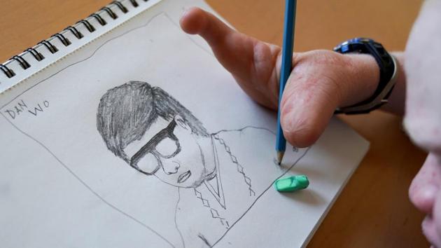 In the above photo, 15 year old Emmanuel Rutema sketches a portrait at his temporary foster home in New York.In a witchcraft driven attack, his arm and fingers were chopped off and part of his tongue pulled out. (Carlo Allegri/REUTERS) In the above photo, 15 year old Emmanuel Rutema sketches a portrait at his temporary foster home in New York.In a witchcraft driven attack, his arm and fingers were chopped off and part of his tongue pulled out. (Carlo Allegri/REUTERS)