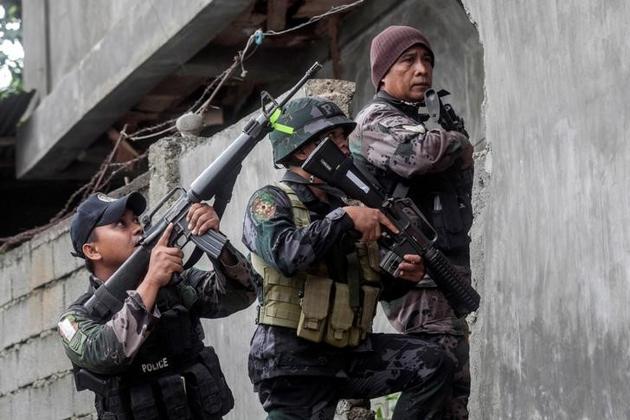 A joint group of police and military forces conduct a house-to-house search in Marawi city. (Reuters) A joint group of police and military forces conduct a house-to-house search in Marawi city. (Reuters)