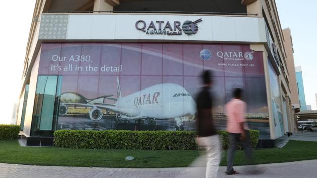 People walk past the Qatar Airways office in Manama, Bahrain. (REUTERS) People walk past the Qatar Airways office in Manama, Bahrain. (REUTERS)