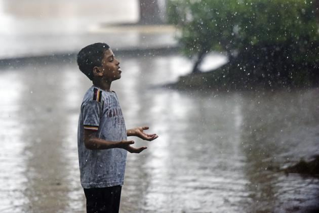 A boy enjoys the rain at Shivaji Park on Friday.(Pratik Chorge/HT Photo)