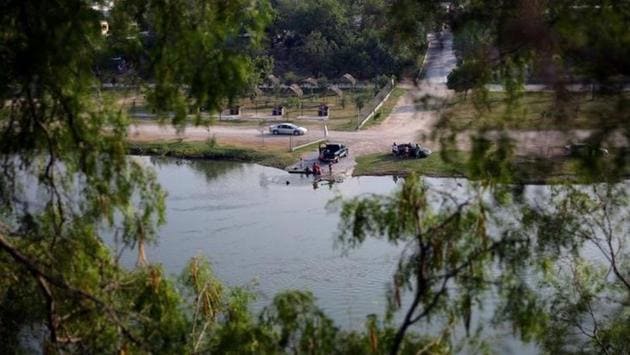 Local residents of Ciudad Miguel Aleman town are seen by the Rio Grande river at the border between United States and Mexico, in Roma, Texas. (REUTERS) Local residents of Ciudad Miguel Aleman town are seen by the Rio Grande river at the border between United States and Mexico, in Roma, Texas. (REUTERS)