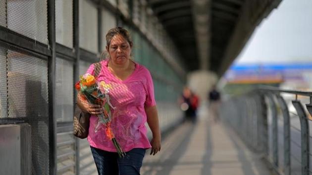 A woman crosses a bridge over the Rio Grande river at a pedestrian port of entry from Mexico to the United States. (REUTERS) A woman crosses a bridge over the Rio Grande river at a pedestrian port of entry from Mexico to the United States. (REUTERS)