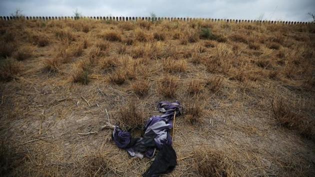 Abandoned clothing is seen near the US-Mexico border fence. (REUTERS) Abandoned clothing is seen near the US-Mexico border fence. (REUTERS)