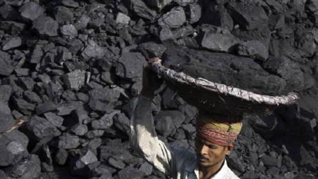 A man carrying coal at an open mine.(Reuters Photo)