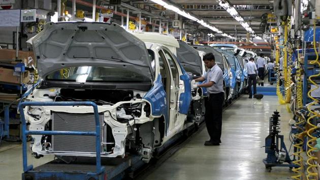 Employees work inside a plant of General Motors India Ltd. at Halol, about 150 (93 miles) from Ahmedabad.(REUTERS)