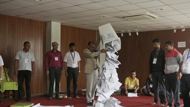 A Nepalese election commission officer empties a ballot box prior to counting the votes of local elections in Kathmandu on May 15. The second phase of the polls is scheduled on June 28.(AP File)