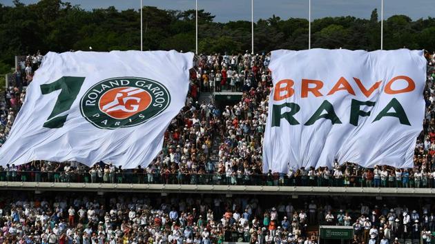 People wave a giant flag after Spain's Rafael Nadal won a record 10th French Open title. (AFP) People wave a giant flag after Spain's Rafael Nadal won a record 10th French Open title. (AFP)