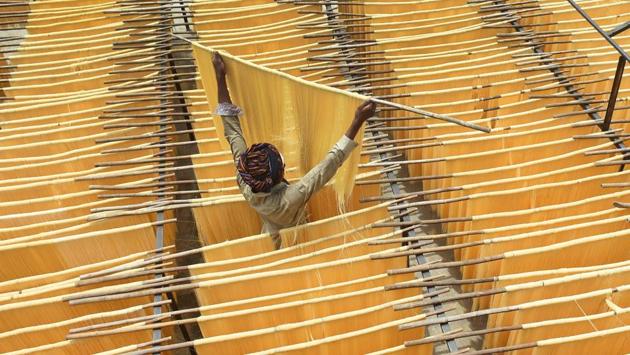 A Pakistani man dries Seviiyan (thin vermicelli), which is used for the preparation of 'sheerkhurma', a traditional sweet dish prepared by the Muslim community during the holy month of Ramadan, at a factory in Lahore. (ARIF ALI / AFP)