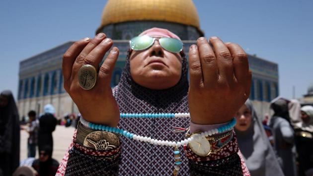 A Palestinian Muslim worshipper attends the second Friday prayers of the Muslim holy month of Ramadan in front of the Dome of the Rock at Jerusalem's al-Aqsa mosque compound. (AHMAD GHARABLI / AFP)