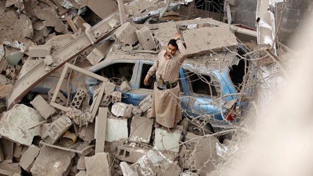 A Yemeni man reacts on the rubble of houses destroyed in a suspected Saudi-led coalition air strike in Sanaa. Four civilians, including two teenagers, died ‘in a strike by the coalition that targeted a civilian house behind the presidential palace in the south of the capital’, a medical source said. (MOHAMMED HUWAIS / AFP)