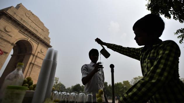 An 11-year-old boy sells lemonade near India Gate, in New Delhi. According to the UNICEF, there are approximately more than 28 million children under the age of 14 working as child labourers in India. Child labor is widely prevalent in India despite laws that seek to keep children in school. These laws are regularly flouted as large numbers of children are forced into difficult and dangerous jobs. (Burhaan Kinu/HT PHOTO)