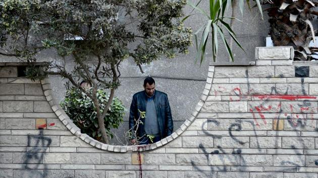 A plainclothes policeman inspects the scene outside a building where an explosion took place in the southern suburb of Maadi in the Egyptian capital Cairo on March 24, 2017. According to a statement by the interior ministry, the blast which was caused by a "strange metal device" killed a 35-year-old doorman as he cleaned a garden, in addition to injuring his wife and two sons. Islamist militants have set off bombs in Cairo, usually targeting policemen, since the 2013 overthrow of president Mohamed Morsi, a Muslim Brotherhood politician. (AFP FILE) A plainclothes policeman inspects the scene outside a building where an explosion took place in the southern suburb of Maadi in the Egyptian capital Cairo on March 24, 2017. According to a statement by the interior ministry, the blast which was caused by a "strange metal device" killed a 35-year-old doorman as he cleaned a garden, in addition to injuring his wife and two sons. Islamist militants have set off bombs in Cairo, usually targeting policemen, since the 2013 overthrow of president Mohamed Morsi, a Muslim Brotherhood politician. (AFP FILE)