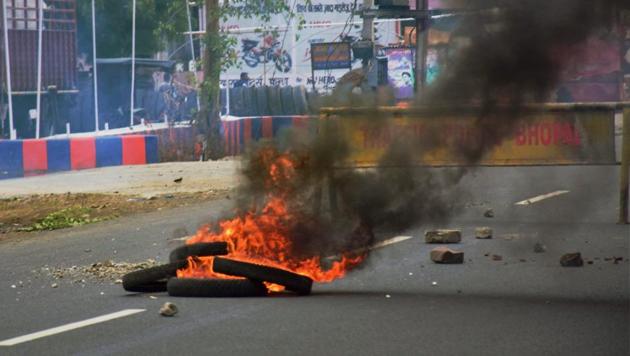 Agitated farmers burnt tyres as they blocked roads at Fanda village near Bhopal on Friday. (PTI Photo) Agitated farmers burnt tyres as they blocked roads at Fanda village near Bhopal on Friday. (PTI Photo)