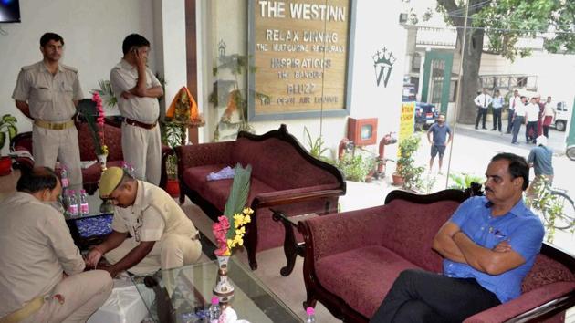 Police officials raid on the hotel of ARTO RS Yadav in Varanasi. (PTI) Police officials raid on the hotel of ARTO RS Yadav in Varanasi. (PTI)