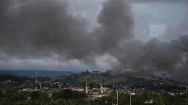 In this June 9 photo, black smoke from continuing military air strikes rises above a mosque in Marawi city, southern Philippines.(AP Photo)