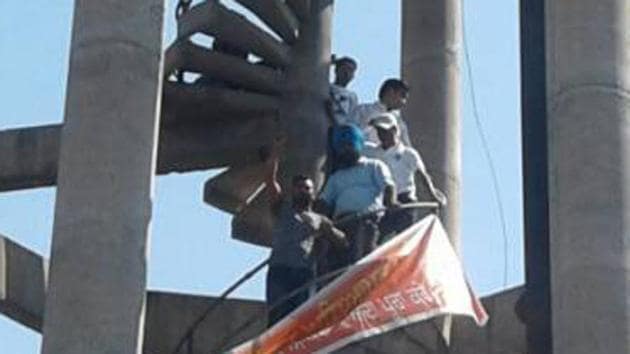 Siksha providers protesting against the non-payment of salaries on a water tank in Dinanagar on Sunday. (HT Photo) Siksha providers protesting against the non-payment of salaries on a water tank in Dinanagar on Sunday. (HT Photo)
