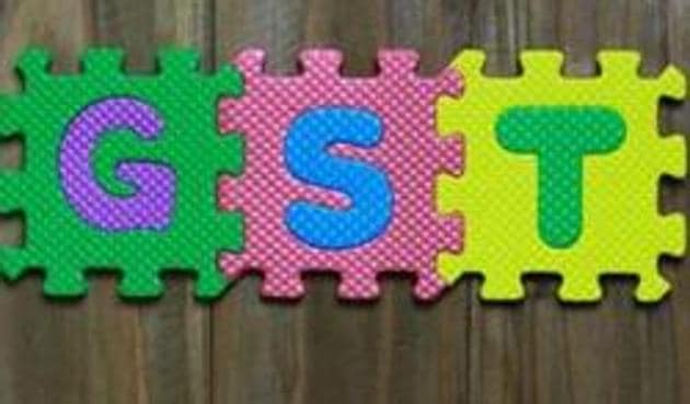 Colourful puzzle block letter with word GST on wood background (Getty Images/iStockphoto)
