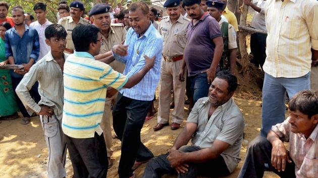 Family members of two persons who were trapped in an underground fire after land caved-in a coal mine area at Jharia Sindri main road, mourn in Dhanbad.