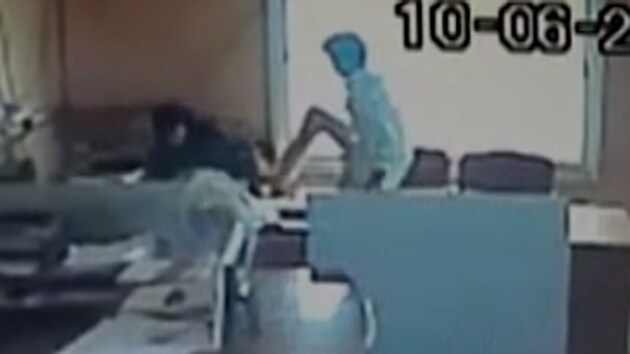 An employee kicks a female colleague at Sindhanur city corporation in Karnataka’s Raichur.(Screenshot)
